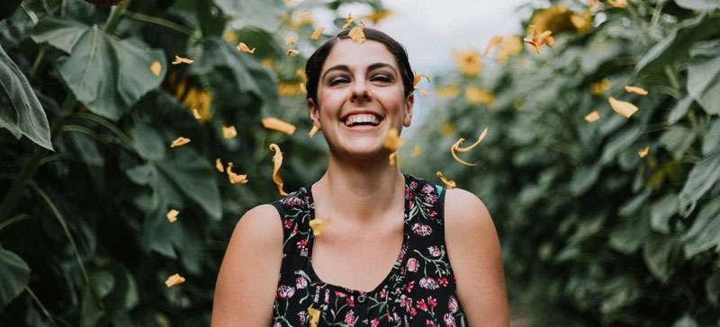 woman-smiling among flowers