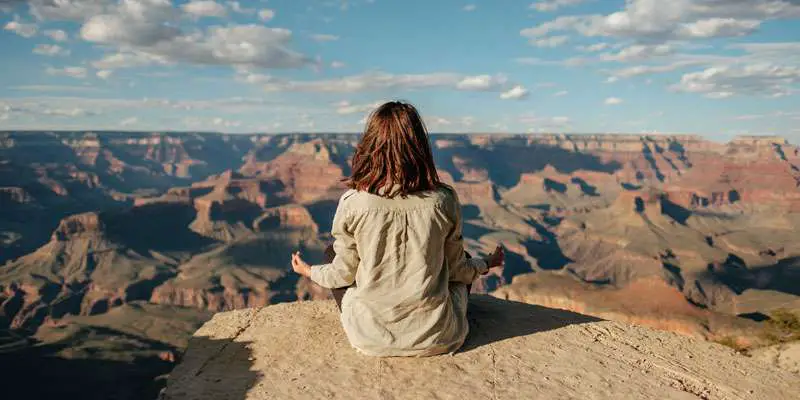 girl meditating on a mountain
