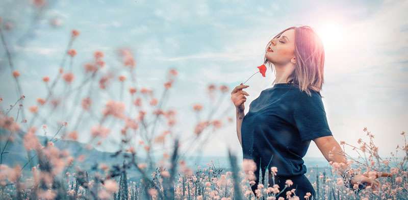 womand feeling grounded with flowers around her