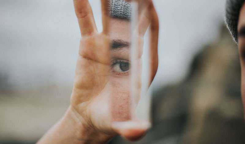 woman looking at her mirror