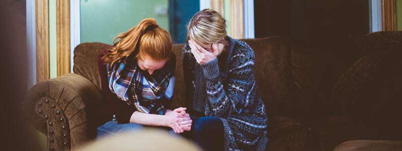 girl asking forgiveness to her friend