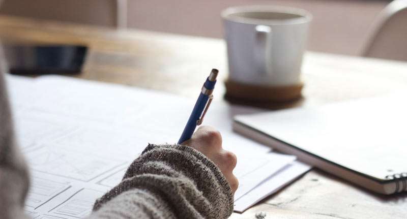 person writing a letter