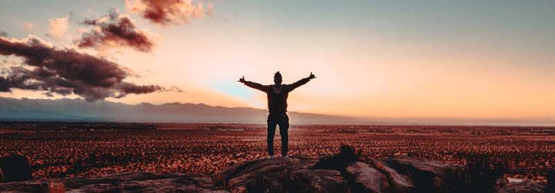 man feeling happy in the desert