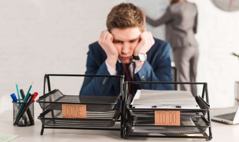 man overwhelmed by the tasks to do