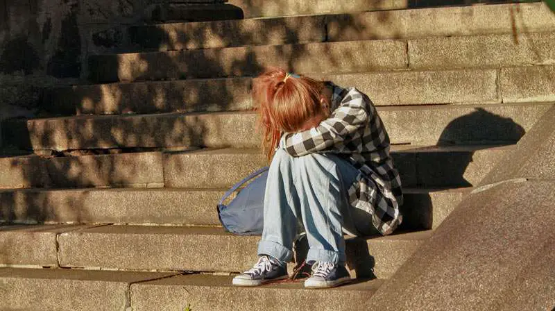 girl feeling sad on the stairs