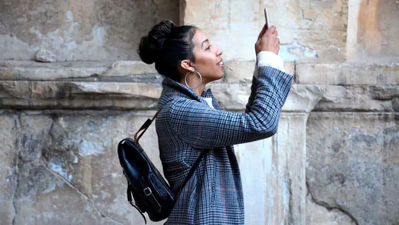 woman taking a picture with her phone