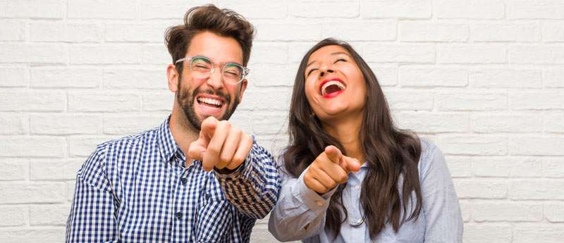 man and woman making fun of someone else