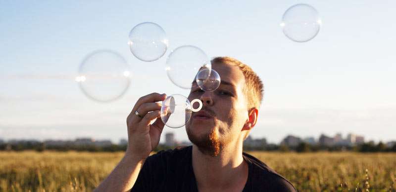 man making soap bubbles