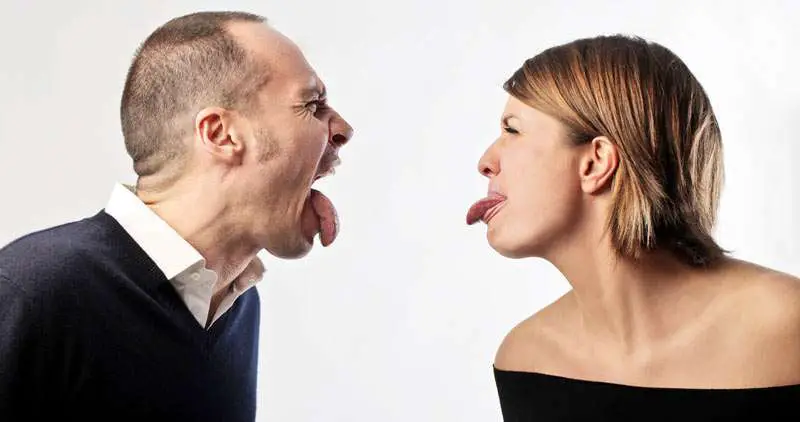 couple arguing and sticking tongue out