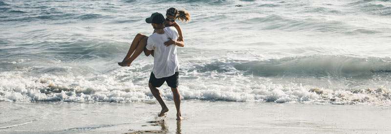 couple fooling around on the beach