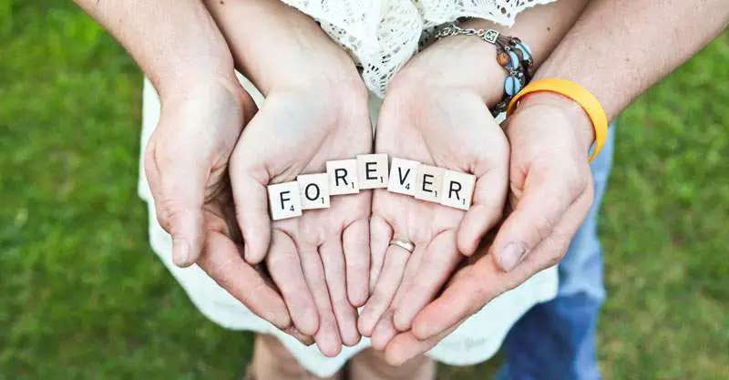 couple hands holding letters meaning forever