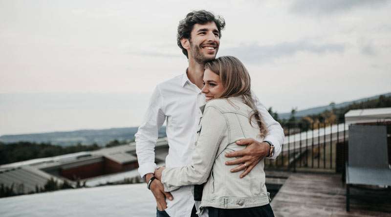 man and woman hugging