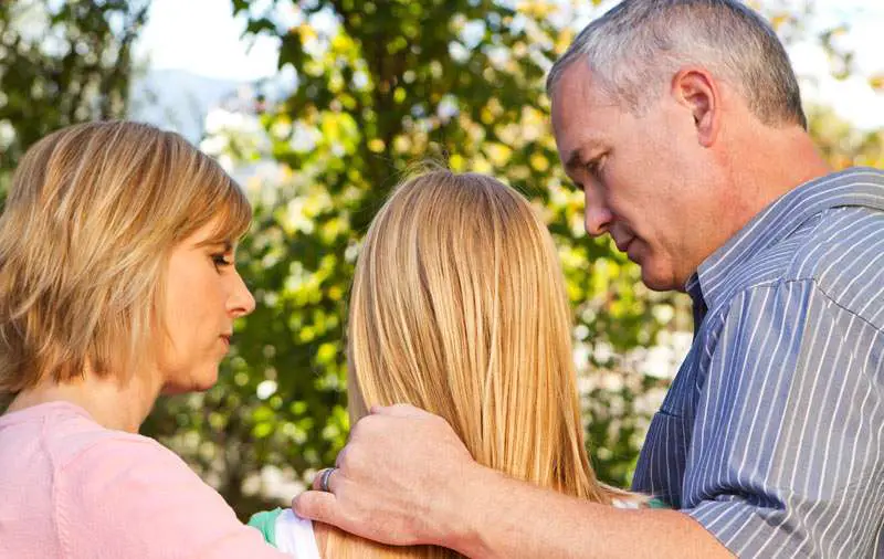 parents giving some advice to their daughter