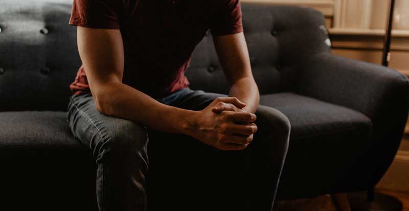 man seated talking to a counselor