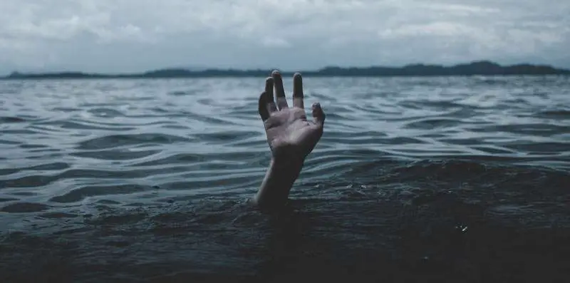 hand from water asking for help