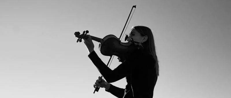 woman practicing violin