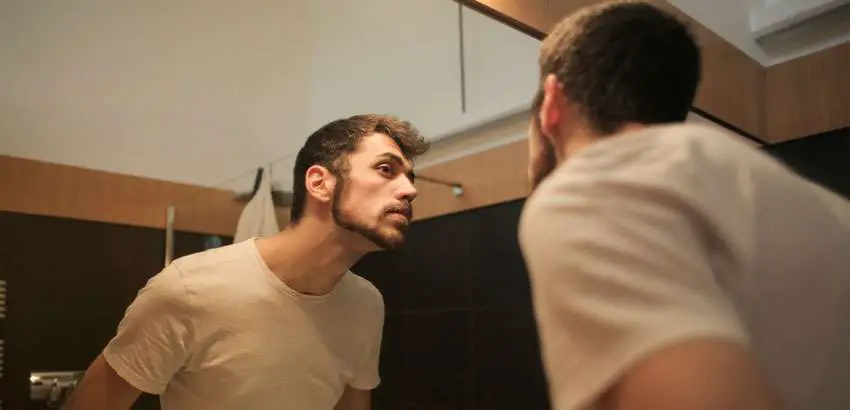 man obsessed with his looks on the mirror