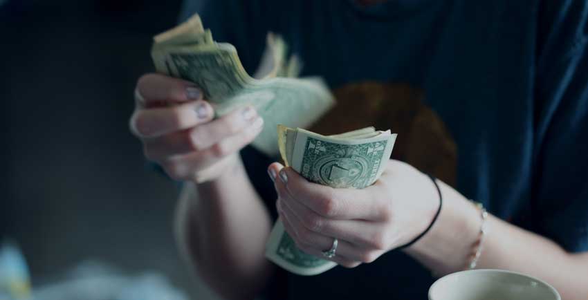 person counting her money publicly