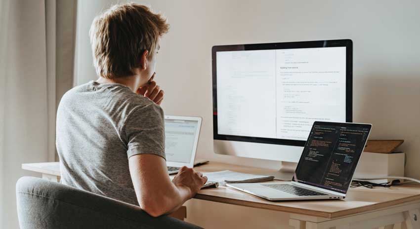 man working alone with computers