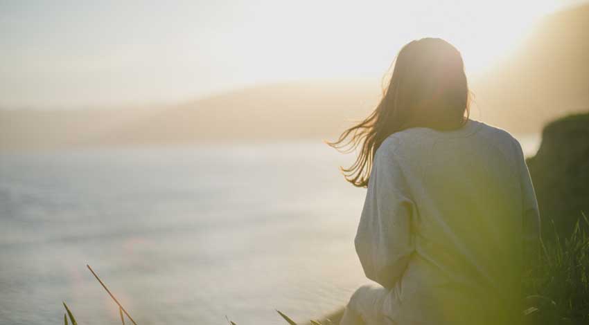 woman alone looking at the shore