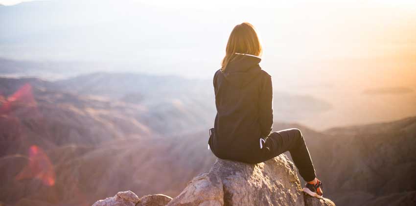 woman on the top of a mountain